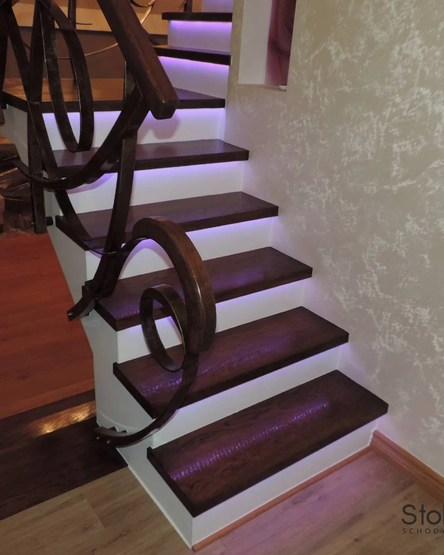Zbliżenie na kute zawijasy balustrady przy pierwszych stopniach ze światłem LED pod nosami — Sanok